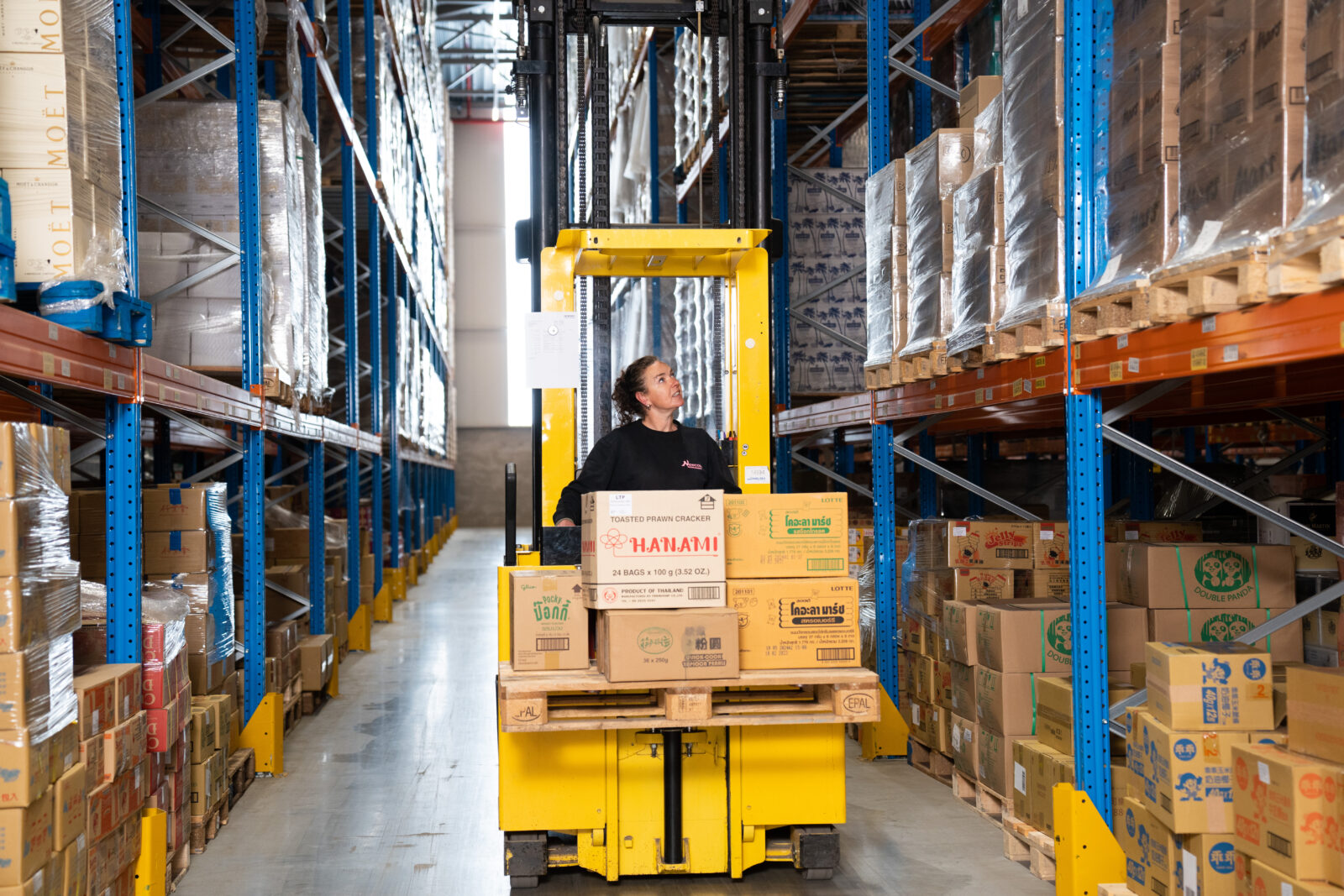 Employee drives a yellow car through our warehouse in the Netherlands